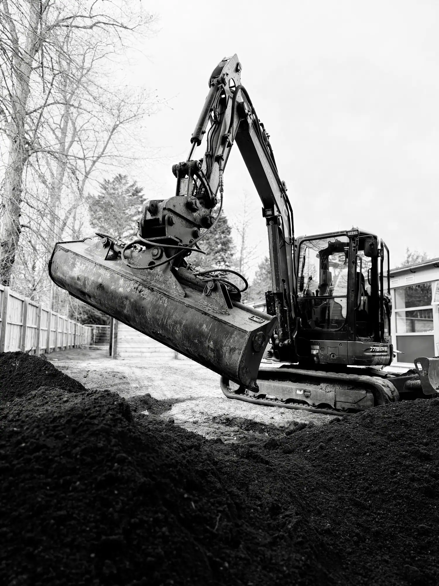 Grading and levelling ground with an excavator