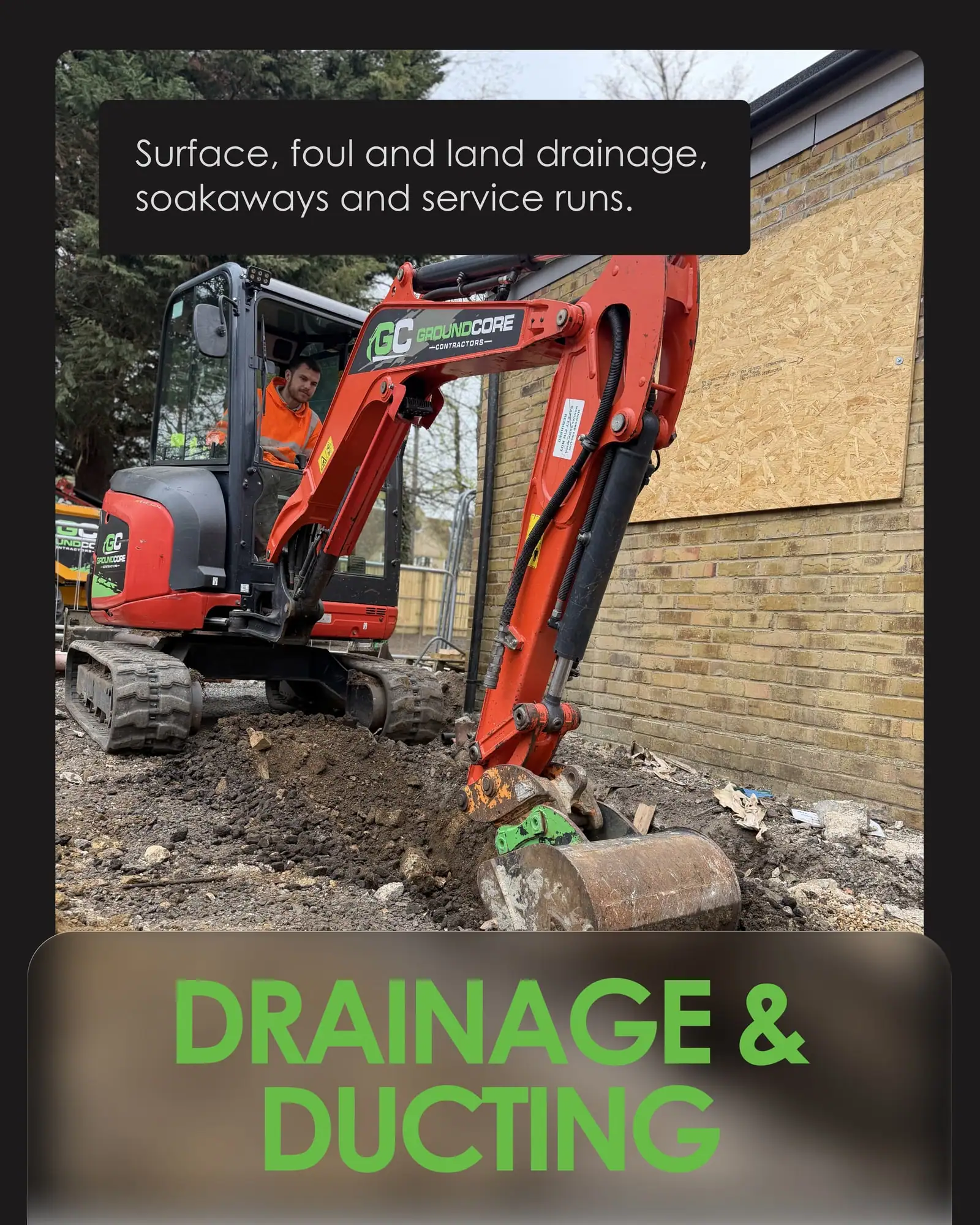 Drainage and ducting slide: a GroundCore excavator digging a trench beside a building