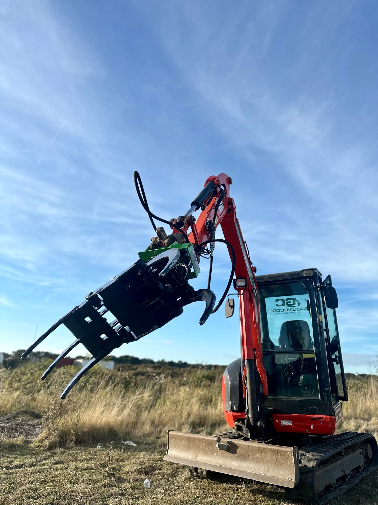 A GroundCore excavator fitted with a hydraulic shear for clearing trees on site